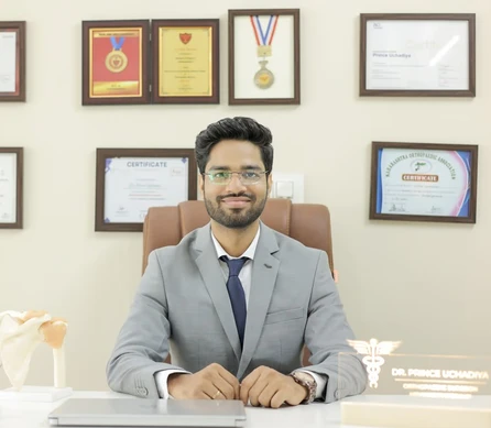 Dr. Prince Uchadiya, best arthroscopic surgeon in Vijay Nagar Indore, sitting in his clinic office and consulting patients with warmth and expertise.
